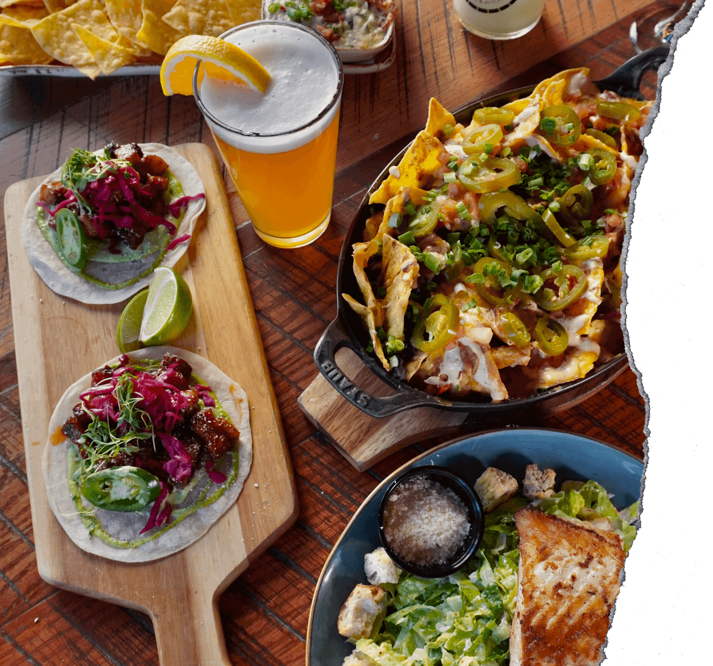 a spread of food and drinks on a wooden table