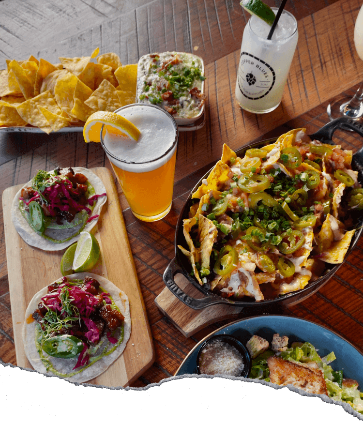 a spread of food and drinks on a wooden table