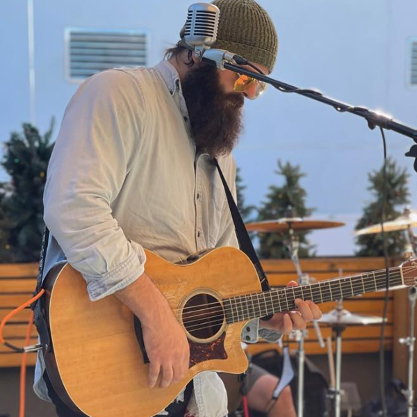 Man wearing sunglasses playing guitar