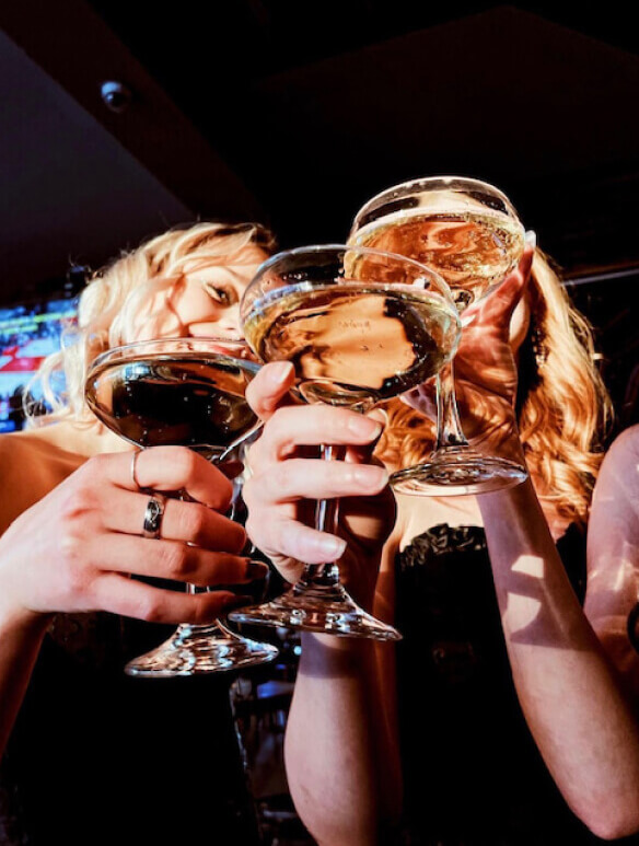 a group of women cheersing glasses