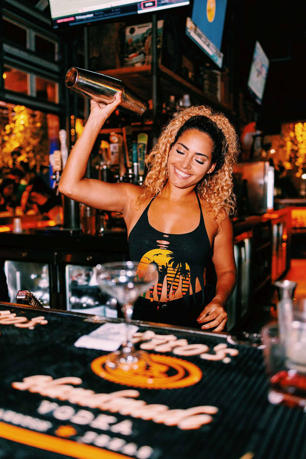 a bartender pouring a cocktail